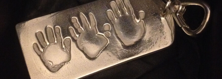 Silver key chain with hand prints