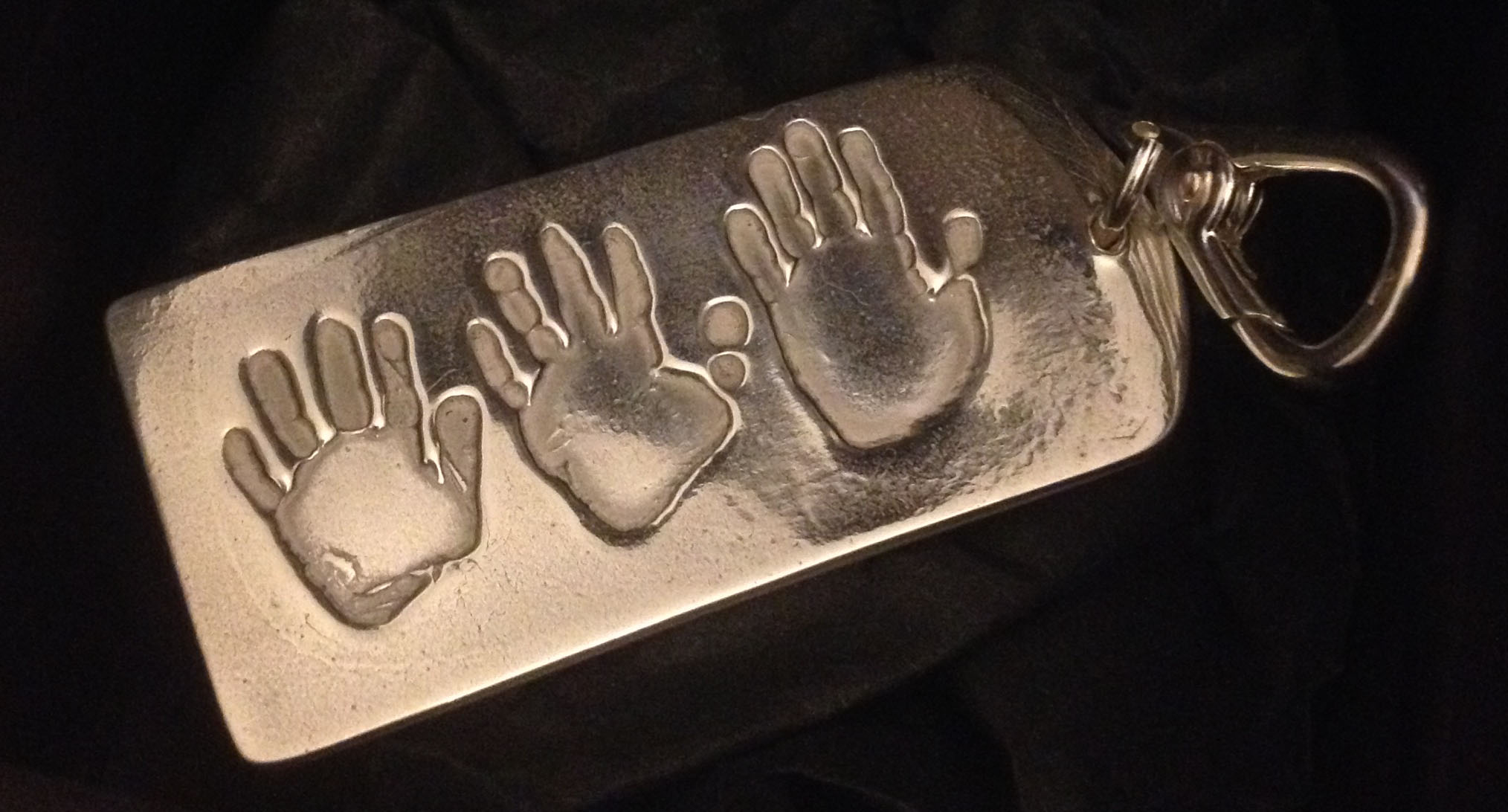 Silver key chain with hand prints