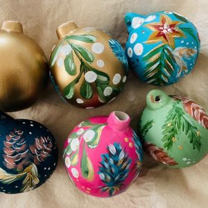 Adult paint a bauble with prosecco